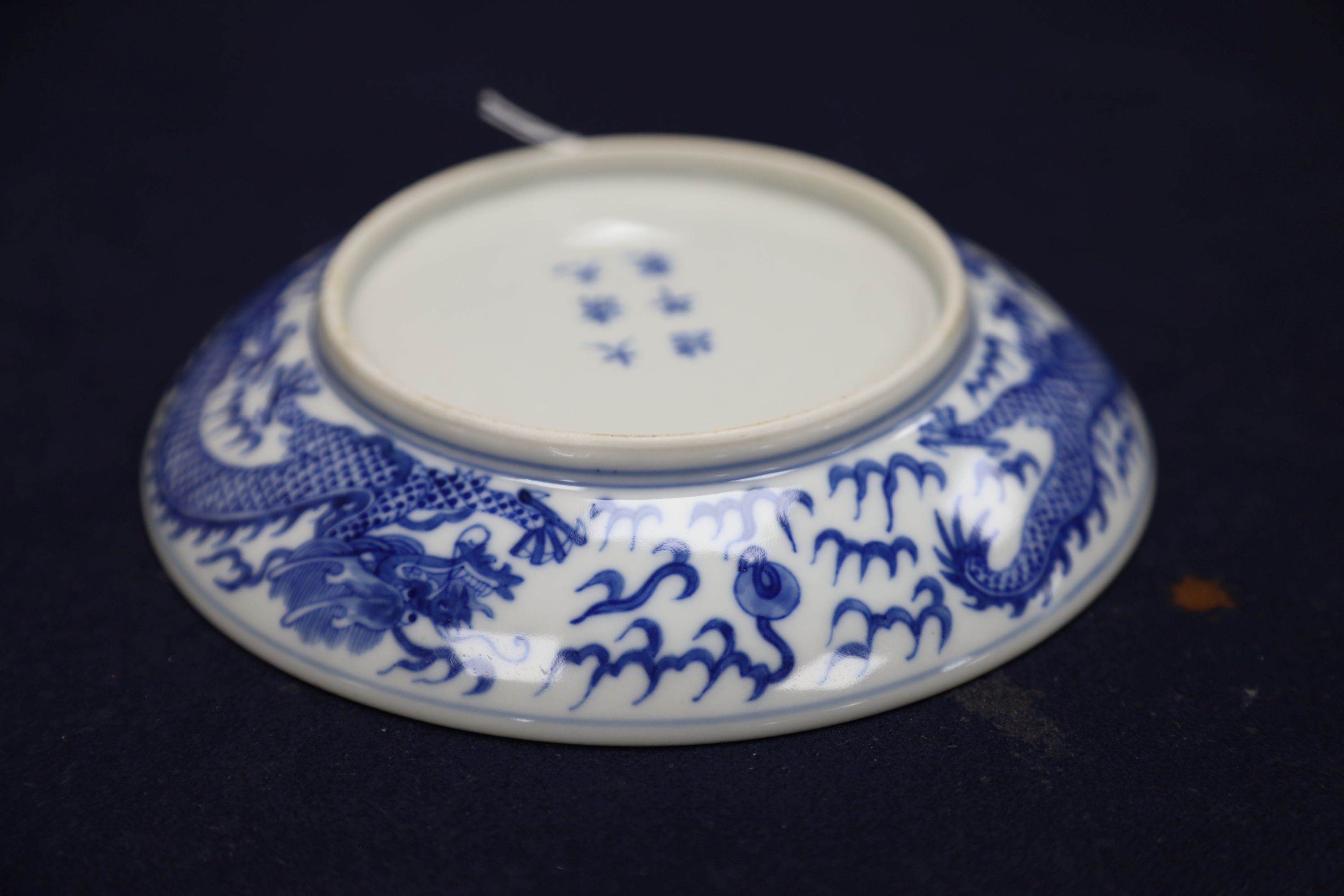 A Chinese blue and white landscape bowl, a/f and a Chinese blue and white 'dragon' dish, 18cm and 16.5cm